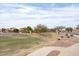 View of the community park with a playground and lush green space at 24868 W Kowalsky Ln, Buckeye, AZ 85326