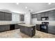 Updated kitchen featuring dark cabinets, modern appliances, and a center island at 24868 W Kowalsky Ln, Buckeye, AZ 85326