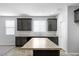 Kitchen showcasing dark cabinets, stainless steel appliances, and a center island at 24868 W Kowalsky Ln, Buckeye, AZ 85326