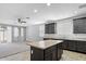 Kitchen with center island opening up to the living room at 24868 W Kowalsky Ln, Buckeye, AZ 85326