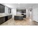 Spacious kitchen with dark cabinets and a center island at 24868 W Kowalsky Ln, Buckeye, AZ 85326