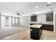 Open kitchen features a center island and dark cabinets at 24868 W Kowalsky Ln, Buckeye, AZ 85326