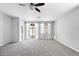 Spacious living room showcasing natural light and plush carpet at 24868 W Kowalsky Ln, Buckeye, AZ 85326