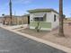 Quaint home featuring a desert-style landscape, shade awning, and a well-kept exterior at 25 S 102Nd St # 47, Mesa, AZ 85208