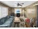 Cozy living room with wood paneling, a fireplace, and comfortable seating for a relaxed atmosphere at 25 S 102Nd St # 47, Mesa, AZ 85208