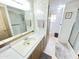 A bathroom featuring a large mirror, vanity and a shower with glass door at 25 S 102Nd St # 73, Mesa, AZ 85208