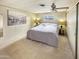 A cozy bedroom featuring a queen-sized bed, neutral carpet and a ceiling fan at 25 S 102Nd St # 73, Mesa, AZ 85208
