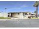 Inviting manufactured home with a covered parking, mature landscaping, and a welcoming entrance at 25 S 102Nd St # 73, Mesa, AZ 85208
