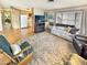 Open-concept living space with a cozy sofa, fireplace, and view into the well-lit kitchen area at 25 S 102Nd St # 73, Mesa, AZ 85208