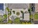 An aerial view shows an expansive patio with a fire pit, water feature, and outdoor dining area in a landscaped yard at 30406 N 116Th Ln, Peoria, AZ 85383