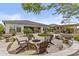 Expansive backyard with a fire pit, fountain, dining area, mature landscaping, and outdoor kitchen at 30406 N 116Th Ln, Peoria, AZ 85383