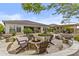 Spacious backyard featuring a fire pit, outdoor kitchen, and lush landscaping at 30406 N 116Th Ln, Peoria, AZ 85383