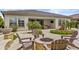 Elegant backyard boasts a stone fire pit, a water feature, and an outdoor seating area for relaxing and entertaining at 30406 N 116Th Ln, Peoria, AZ 85383