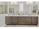 Elegant bathroom featuring dual sinks, stone countertop, and a frameless shower at 30406 N 116Th Ln, Peoria, AZ 85383