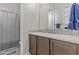Well-lit bathroom featuring a vanity with stylish fixtures, and a shower/tub combination at 30406 N 116Th Ln, Peoria, AZ 85383