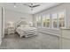 Bright bedroom with carpet flooring, plantation shutters and ceiling fan at 30406 N 116Th Ln, Peoria, AZ 85383