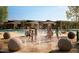 Community pool with splash pad, lounge chairs, and desert views at 30406 N 116Th Ln, Peoria, AZ 85383
