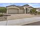 Charming stucco home featuring a tile roof, manicured landscaping, and a spacious three-car garage at 30406 N 116Th Ln, Peoria, AZ 85383