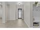 Bright foyer featuring tile flooring, a decorative front door, and a built-in hall tree at 30406 N 116Th Ln, Peoria, AZ 85383