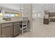 Open-concept kitchen features granite countertops, stainless appliances and desk nook at 30406 N 116Th Ln, Peoria, AZ 85383