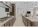 Bright kitchen featuring granite countertops, large island, and stainless-steel appliances at 30406 N 116Th Ln, Peoria, AZ 85383