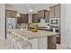 Well-equipped kitchen featuring granite countertops, island with seating, and stainless appliances at 30406 N 116Th Ln, Peoria, AZ 85383