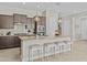 Stylish kitchen with granite countertops, a large island with seating and pendant lighting at 30406 N 116Th Ln, Peoria, AZ 85383