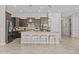 Contemporary kitchen featuring a large island with seating, modern pendant lights, and stainless appliances at 30406 N 116Th Ln, Peoria, AZ 85383