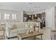 Open-concept living area flows to kitchen with modern design and warm, neutral colors at 30406 N 116Th Ln, Peoria, AZ 85383