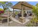 Covered outdoor patio features dining, lounge, and cooking areas, plus a hammock for the ultimate in backyard relaxation at 30406 N 116Th Ln, Peoria, AZ 85383