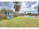 Spacious backyard features a play set, palm tree, pool and a well-maintained lawn at 3149 W Danbury Dr, Phoenix, AZ 85053