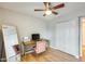 Bright bedroom with wood floors, a ceiling fan, a writing desk, and a pink velvet chair at 3149 W Danbury Dr, Phoenix, AZ 85053