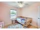 room with light wood floors and a rattan bed frame, bathed in a soft, natural light at 3149 W Danbury Dr, Phoenix, AZ 85053