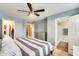 Bright bedroom with hardwood floors and access to an ensuite bathroom and spacious walk-in closet at 3149 W Danbury Dr, Phoenix, AZ 85053