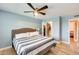 Stylish bedroom with a ceiling fan, hardwood floors, and a walk-in closet providing ample storage space at 3149 W Danbury Dr, Phoenix, AZ 85053