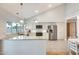 Spacious kitchen with stainless steel appliances, white cabinets, and an island at 3149 W Danbury Dr, Phoenix, AZ 85053