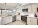 Well-lit kitchen with stainless steel appliances, white cabinets, and stylish countertops at 3149 W Danbury Dr, Phoenix, AZ 85053