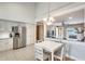 Bright kitchen area with stainless steel refrigerator and a cozy breakfast nook table at 3149 W Danbury Dr, Phoenix, AZ 85053