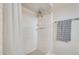 Shower featuring white tiled walls with a shower curtain and a towel rack at 3149 W Danbury Dr, Phoenix, AZ 85053