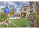 Lush backyard with a sparkling pool, artificial turf, and space for outdoor entertaining at 3270 W White Canyon Rd, San Tan Valley, AZ 85144
