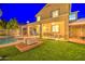 Inviting backyard featuring a covered patio with furniture, a grill area, artificial turf, and a sparkling pool at 3270 W White Canyon Rd, San Tan Valley, AZ 85144