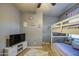 Charming ' bedroom featuring a cozy bunk bed and a modern entertainment center with a large screen TV at 3270 W White Canyon Rd, San Tan Valley, AZ 85144