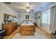 Cozy bedroom with wood floors, ceiling fan, and dresser set with decorative mirror at 3270 W White Canyon Rd, San Tan Valley, AZ 85144