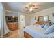 Bright bedroom with wood floors, ceiling fan, and ensuite bathroom at 3270 W White Canyon Rd, San Tan Valley, AZ 85144
