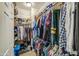Walk-in closet with shelves and multiple rows of hanging clothes at 3270 W White Canyon Rd, San Tan Valley, AZ 85144
