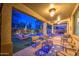 Spacious covered patio with comfortable seating and views of the backyard pool and landscaping at 3270 W White Canyon Rd, San Tan Valley, AZ 85144