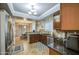 Kitchen with tiled floors, dark wood cabinets, stainless steel appliances, and spacious layout at 3270 W White Canyon Rd, San Tan Valley, AZ 85144