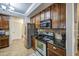 Kitchen with stainless steel appliances and dark wood cabinetry with tile backsplash at 3270 W White Canyon Rd, San Tan Valley, AZ 85144