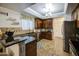Kitchen sink with stainless steel appliances, tile backsplash, and dark wood cabinetry at 3270 W White Canyon Rd, San Tan Valley, AZ 85144