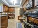 Kitchen with dark wood cabinets, stainless steel appliances, pull out drawers, and tile floor at 3270 W White Canyon Rd, San Tan Valley, AZ 85144